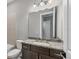 Bathroom features vanity with granite counter, dark wood cabinets and tile flooring at 8962 Baroque Ter, Sarasota, FL 34240
