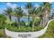 Elegant entrance sign amidst palm trees and landscaping at Artistry Sarasota at 8962 Baroque Ter, Sarasota, FL 34240