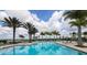 Serene community pool area boasting sparkling water, relaxing lounge chairs, and picturesque palm trees at 8962 Baroque Ter, Sarasota, FL 34240