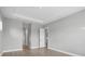 Neutral empty room with wood floors, crown molding, and a view of another room at 8962 Baroque Ter, Sarasota, FL 34240