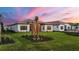 Beautiful single-story home with manicured lawn, landscaping, and a neutral color palette at 8962 Baroque Ter, Sarasota, FL 34240