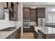 Modern kitchen with stainless steel appliances, granite countertops, and dark wood cabinetry at 8962 Baroque Ter, Sarasota, FL 34240