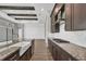 Kitchen featuring a spacious island with a farmhouse sink, granite countertops, and wood cabinets at 8962 Baroque Ter, Sarasota, FL 34240