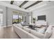 Bright living room boasts beautiful wood beam ceilings and sliding glass doors to the outside living area at 8962 Baroque Ter, Sarasota, FL 34240