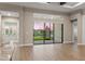 Living room with sliding glass doors, and an outdoor view of a lake and landscaped backyard at 8962 Baroque Ter, Sarasota, FL 34240