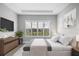 Comfortable bedroom with plush bedding, a dresser, and an outside view through shuttered windows at 8962 Baroque Ter, Sarasota, FL 34240
