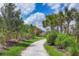 Scenic walking trail through lush greenery and mature trees at 8962 Baroque Ter, Sarasota, FL 34240