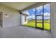 Spacious screened patio offering beautiful views of the landscaped backyard and lake at 8962 Baroque Ter, Sarasota, FL 34240