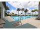 Sparkling community pool surrounded by lounge chairs and swaying palm trees at 8962 Baroque Ter, Sarasota, FL 34240