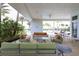 Comfortable poolside lounge area with couches and chairs overlooking the pool and palm trees at 8962 Baroque Ter, Sarasota, FL 34240