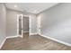 Spacious room features wood-look tile floors, white trim and open glass paneled double doors at 8962 Baroque Ter, Sarasota, FL 34240