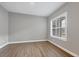 Neutral room features wood-look tile, base trim, double hung window with wood shutter at 8962 Baroque Ter, Sarasota, FL 34240