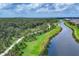 Scenic lakeside walking path surrounded by lush landscaping and mature trees at 8962 Baroque Ter, Sarasota, FL 34240