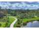 Scenic walking path by the lake with lush landscaping and beautiful trees at 8962 Baroque Ter, Sarasota, FL 34240