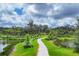 Scenic walking path winding through lush green landscape alongside a serene lake at 8962 Baroque Ter, Sarasota, FL 34240