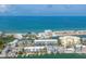 Stunning aerial view of waterfront houses and buildings along the canals and beach, showcasing a vibrant coastal community at 9200 Midnight Pass Rd # 30, Sarasota, FL 34242