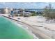 Breathtaking aerial view of beachfront property with turquoise waters and clear skies, offering a serene coastal lifestyle at 9200 Midnight Pass Rd # 30, Sarasota, FL 34242