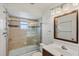 Bathroom featuring tiled shower with glass door, toilet and vanity with sink, and updated lighting at 9200 Midnight Pass Rd # 30, Sarasota, FL 34242