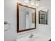 Updated bathroom with a sleek vanity, framed mirror, and modern lighting fixtures at 9200 Midnight Pass Rd # 30, Sarasota, FL 34242