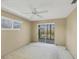 Bedroom featuring a ceiling fan, slider door access to balcony, and a sunny window at 9200 Midnight Pass Rd # 30, Sarasota, FL 34242