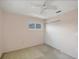 Cozy bedroom with neutral walls, plush carpet, and a ceiling fan for added comfort at 9200 Midnight Pass Rd # 30, Sarasota, FL 34242