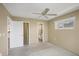 Cozy bedroom featuring neutral tones, a ceiling fan, and ample closet space at 9200 Midnight Pass Rd # 30, Sarasota, FL 34242