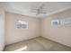 Bedroom with neutral walls, two windows and a ceiling fan at 9200 Midnight Pass Rd # 30, Sarasota, FL 34242