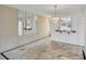 Dining area featuring marble floors, mirrored wall, chandelier, and pass through to kitchen at 9200 Midnight Pass Rd # 30, Sarasota, FL 34242