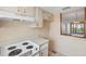 Kitchen showcasing light-toned cabinetry and view to dining area, providing an open feel at 9200 Midnight Pass Rd # 30, Sarasota, FL 34242