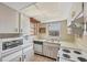 Kitchen with tiled backsplash, stainless steel appliances and a window providing natural light at 9200 Midnight Pass Rd # 30, Sarasota, FL 34242