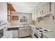 Bright kitchen with wood accents, white appliances, and a sink with views at 9200 Midnight Pass Rd # 30, Sarasota, FL 34242