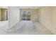 Spacious living room with neutral carpeting and access to a screened-in balcony with neighborhood views at 9200 Midnight Pass Rd # 30, Sarasota, FL 34242