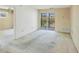 Living room with sliding glass doors to screened lanai with water views and neutral-toned walls at 9200 Midnight Pass Rd # 30, Sarasota, FL 34242