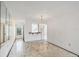 Bright living room with marble tile flooring, a utility window, and decorative chandelier at 9200 Midnight Pass Rd # 30, Sarasota, FL 34242