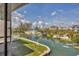 Picturesque waterfront view with docks, lush greenery, and paddle boarders enjoying the water at 9200 Midnight Pass Rd # 30, Sarasota, FL 34242