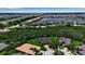 Breathtaking aerial view featuring waterfront properties, lush landscaping, a nearby bridge, and easy access to boating and leisure activities at 932 Mangrove Edge Ct, Bradenton, FL 34208