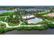 Aerial view of community amenities featuring a pool, playground, lake access, and landscaped grounds at 932 Mangrove Edge Ct, Bradenton, FL 34208