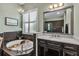 Bathroom with tub, plantation shutters, black tiled walls, and a chandelier at 932 Mangrove Edge Ct, Bradenton, FL 34208