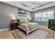 Charming bedroom features a tray ceiling, shutters, and neutral paint at 932 Mangrove Edge Ct, Bradenton, FL 34208