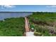 Scenic community boardwalk surrounded by lush greenery and water views, perfect for a relaxing stroll at 932 Mangrove Edge Ct, Bradenton, FL 34208