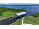 Aerial view of a private boat lift and dock with access to the water, with well-maintained landscaping at 932 Mangrove Edge Ct, Bradenton, FL 34208