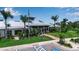 Community clubhouse featuring a modern design, lush landscaping, and convenient parking for residents and guests at 932 Mangrove Edge Ct, Bradenton, FL 34208