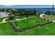 Beautiful community dog park featuring lush green space, secure fencing, seating, and walking paths at 932 Mangrove Edge Ct, Bradenton, FL 34208