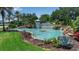 Community entrance featuring a decorative pond, water features, and lush landscaping, highlighting the beautiful Tidewater Reserve at 932 Mangrove Edge Ct, Bradenton, FL 34208