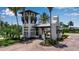 A gated entrance with a guard house welcomes you, surrounded by manicured landscaping and mature palm trees at 932 Mangrove Edge Ct, Bradenton, FL 34208