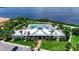 Community center exterior with a pool and patio, overlooking the waterfront with lush green landscaping at 932 Mangrove Edge Ct, Bradenton, FL 34208