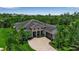 Stunning exterior view showcasing landscaping, driveway, and beautiful architectural details at 932 Mangrove Edge Ct, Bradenton, FL 34208
