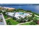 Exterior of a community center with a swimming pool, patio, and landscaping near a body of water at 932 Mangrove Edge Ct, Bradenton, FL 34208