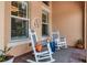 Charming front porch with rocking chairs, decorative pillows, and a welcoming entrance at 932 Mangrove Edge Ct, Bradenton, FL 34208