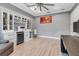Bright home office featuring a wine refrigerator, white cabinets, and hardwood flooring at 932 Mangrove Edge Ct, Bradenton, FL 34208